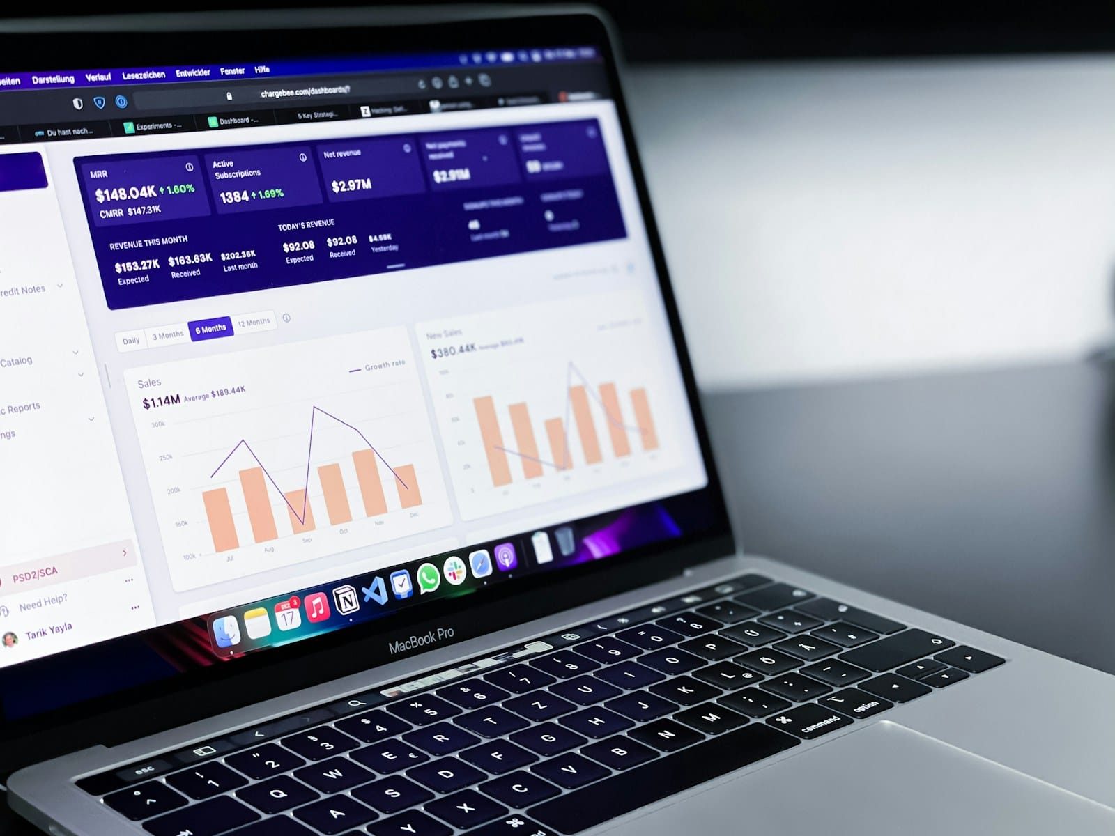 A SaaS revenue dashboard open on a MacBook.