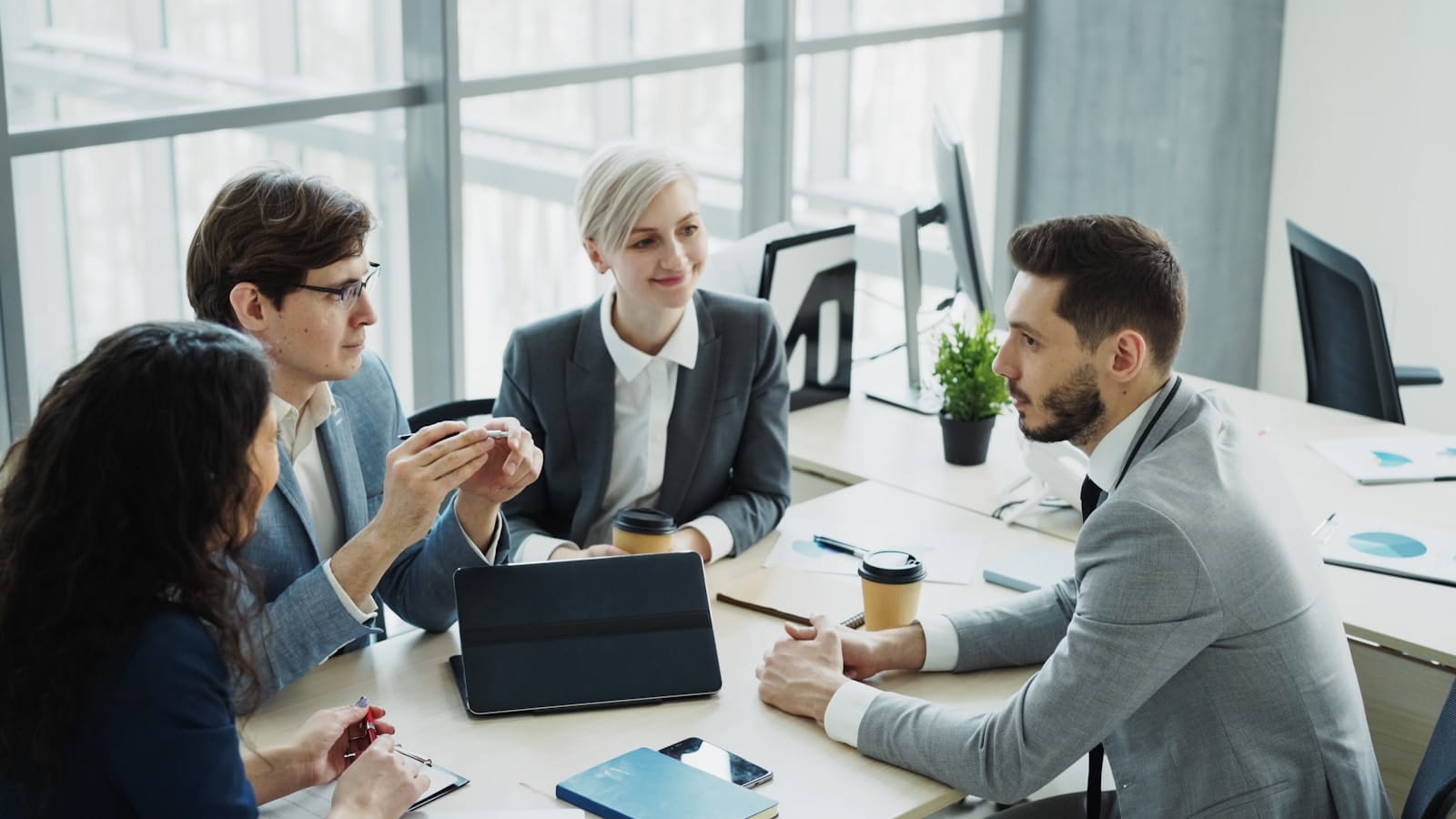 Advisers discussing strategy around a table.